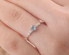 a woman's hand with a diamond ring on top of her finger and an engagement band