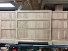 a large wooden dresser sitting on top of a shelf