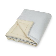 a white and grey blanket folded on top of each other