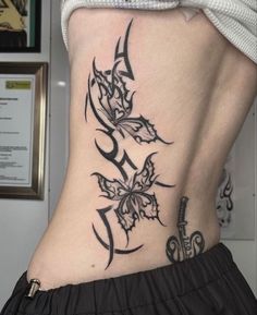 a woman's lower back tattoo is shown