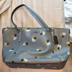 Authentic Coach Purse Never Been Used In Perfect Condition! Pretty Pigeon Blue Color With Flower Design. Elegant Blue Bags With Floral Print, Chic Blue Floral Print Bag, Elegant Blue Floral Print Bags, Blue Floral Print Bags For Shopping, Blue Floral Print Shopping Bags, Pretty Pigeon, Pigeon Blue, Blue Coach, Tan Handbags