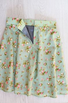 a green skirt with pink flowers on it