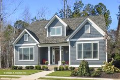 a gray house with white trim and windows