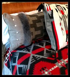 three pillows on top of each other with different patterns and colors in the same pattern