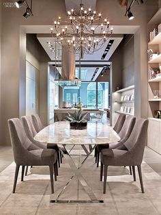 a dining room table with chairs and a chandelier