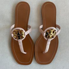 This Is A Pair Of Brand New Tory Burch Miller Thong Sandals. They Are Seashell In Color And A Size 7. Open Toe T-Strap Thong Design Gold-Tone Logo Emblem Leather Upper, Lining And Sole Made In Brazil You Will Receive Exactly What Is Pictured! They Will Ship With The Box. Purchased From Bloomingdale's And Guaranteed 100% Authentic. Retail Price Is $178. Tan Leather Open Toe Flip Flops, Chic Adjustable Leather Flip Flops, Adjustable Tan Leather Sandals, Pink Leather Toe Post Sandals, Chic Tan Sandals With Single Toe Strap, Pink Toe Post Leather Sandals, Tan Leather Sandals With Single Toe Strap, Tan Leather T-strap Sandals, Tropical Shoes