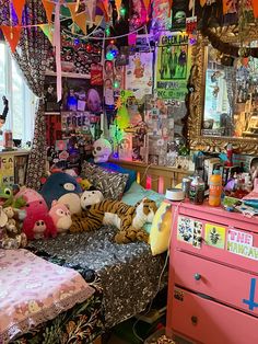 a room filled with lots of stuffed animals and decorations hanging from the ceiling over a bed