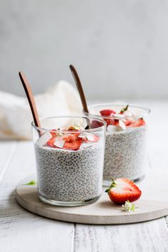 two glasses filled with chia pudding and strawberries