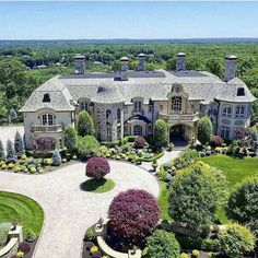 an aerial view of a large home surrounded by trees