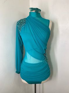 a mannequin wearing a blue dress with beading on it