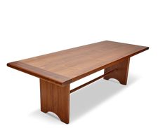 a large wooden table sitting on top of a white floor