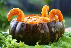 a bowl filled with shrimp and garnish on top of lettuce