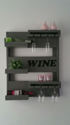 a wall mounted wine rack with glasses and bottles