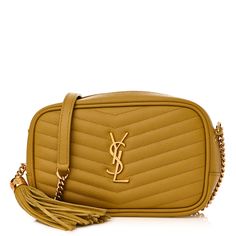 This is an authentic SAINT LAURENT Grain De Poudre Matelasse Monogram Mini Lou Camera Bag in Light Chartreuse. This chic shoulder bag is crafted of beautiful textured calfskin leather in yellow. It features a gold chain cross-body strap with a leather shoulder pad, a rear pocket, and a gold YSL logo. The top zipper opens to a compact black leather interior with card slots. Ysl Logo, Bag Light, Leather Interior, Shoulder Pads, Gold Chain, Camera Bag, Gold Chains, Cross Body, Card Slots