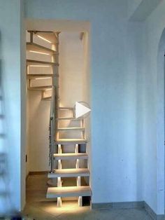 an empty room with stairs leading up to the ceiling and light coming in from behind