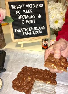 a person holding some kind of food in front of a sign that says weight watchers no bake brownies o point the state island family com