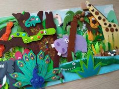 an assortment of felt animals and plants on a table