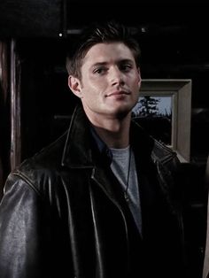 the young man is wearing a black leather jacket