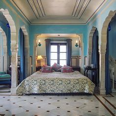 a large bed sitting inside of a bedroom on top of a tiled floor