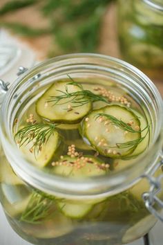 pickled cucumbers with herbs in a jar