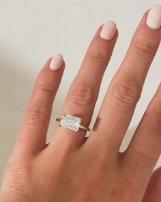 a woman's hand with a ring on it and a baguette in the middle