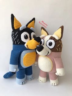 two crocheted stuffed animals standing next to each other