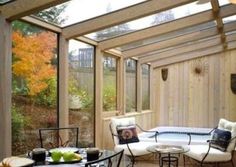 an enclosed patio with chairs, tables and fruit on the table in front of it