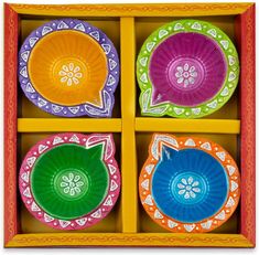 four colorful plates in a wooden box