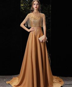 Description Gold round neck satin beads long prom dress gold formal dress Material:satin, beads Size:US 2, US4, US 6, US 8, US 10, US 12 US 2 Bust(inch)32 1/2 Waist(inch)25 1/2 Hips(inch)35 3/4 Shoulder to Floor(inch)58US 4 Bust(inch)33 1/2 Waist(inch)26 1/2 Hips(inch)36 3/4 Shoulder to Floor(inch)58US 6 Bust(inch)34 1/2 Waist(inch)27 1/2 Hips(inch)37 3/4 Shoulder to Floor(inch)59US 8 Bust(inch)35 1/2 Waist(inch)28 1/2 Hips(inch)38 3/4 Shoulder to Floor(inch)59US 10 Bust(inch)36 1/2 Waist(inch)2 Prom Dress Gold, Gold Formal Dress, Grey Evening Dresses, Prom Dress With Train, Y2k Aesthetic Fashion, 60's Dress, Tulle Evening Dress, Short Prom Dress, Dress Gold