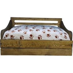 a wooden bed with paw prints on the sheets and pillowcase is shown in front of a white background