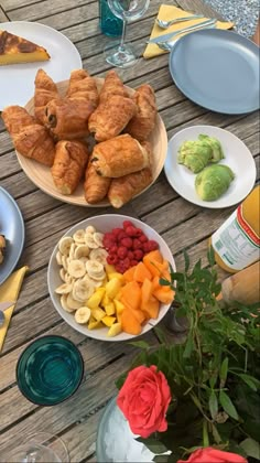 a table topped with plates and bowls filled with food