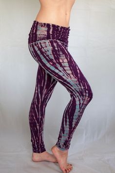 a woman in purple and blue patterned leggings with her hands on her hips