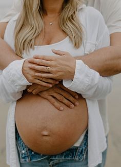 a pregnant woman with her hands on her belly