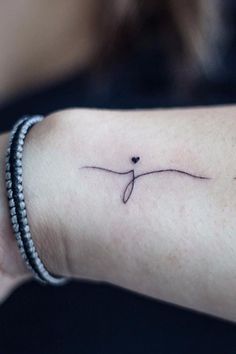 a small tattoo on the wrist that says, 35 initial tattoos perfect for all ages