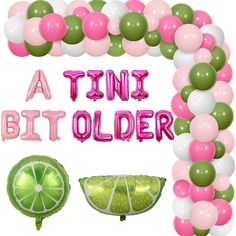 a pink, green and white balloon arch with the words tint a bit older