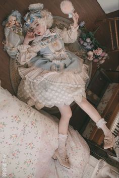 a doll laying on top of a bed in a room