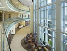 an empty lobby with lots of windows and furniture