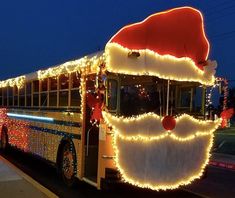 a school bus decorated with christmas lights and a santa hat