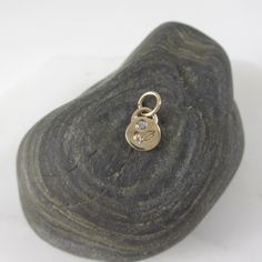 This adorable charm is entirely hand-crafted from recycled 14k gold, which I melt down and form into this petite, organic little pendant. It is then hand-stamped with two sweet leaves and is finished with a genuine flush set diamond. Available with either a shiny gold or satin finish. Includes an open jumpring for hanging. It will be your favorite new spring necklace! *This listing is for one Diamond Petal Charm only. Chain not included and shown with other charms for layering options. :: Solid Dainty Yellow Gold Charms With Birthstone, Dainty Yellow Gold Birthstone Charms, Minimalist 14k Gold Pendant Charm, Delicate Recycled Gold Pendant Charm Necklace, Personalized Pendant Charm Necklace In Recycled Gold, Minimalist 14k Yellow Gold Charms, Dainty 14k Gold Charm Necklace With Flower Charm, Nickel-free 14k Yellow Gold Charm Necklace, Spring Necklace