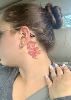 a woman with a red tattoo on her neck