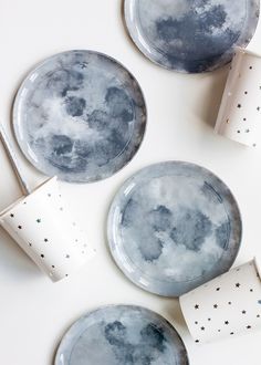 three plates and two cups with the moon on them