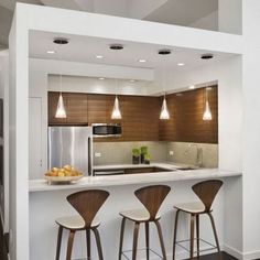 three bar stools sit in front of the kitchen counter