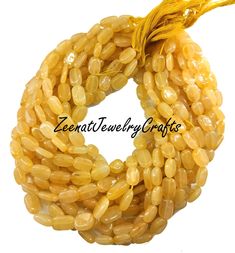 yellow beads with tassels on white background