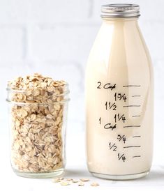 a glass jar filled with oatmeal next to a measuring cup full of oats