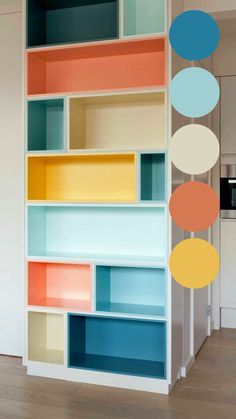 an open book shelf with different colored shelves on it and circles hanging from the ceiling