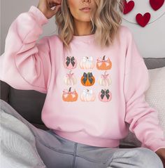 This Pumpkin Bow Crewneck Sweatshirt is the perfect cozy addition to your fall wardrobe. With a cute pumpkin design, it exudes a seasonal vibe that is great for autumn. Ideal for women looking for a stylish and comfortable fall sweater to wear during the colder months. Product features - Knit in one piece without side seams for reduced fabric waste - Ribbed knit collar with seam for shape retention - Made with a medium-heavy fabric blend of 50% cotton and 50% polyester - Classic fit and crew nec Funny Sweatshirts, Cute Pumpkin, Pumpkin Design, Fall Sweaters, Fall Wardrobe, Halloween Funny, Halloween Shirt, Halloween Gifts, Ribbed Knit