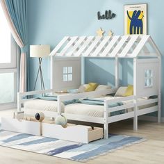 a child's bedroom with blue walls, white furniture and a doll house bed