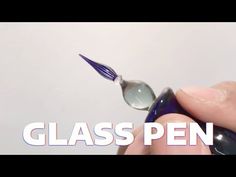 a person holding a glass pen in their left hand with the words glass pen on it