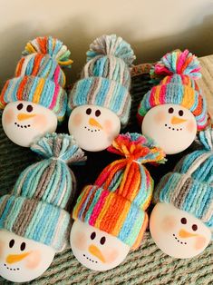 six snowmen wearing knitted hats and scarves