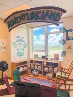 a room with chairs, bookshelves and a sign that says adventureland on the wall